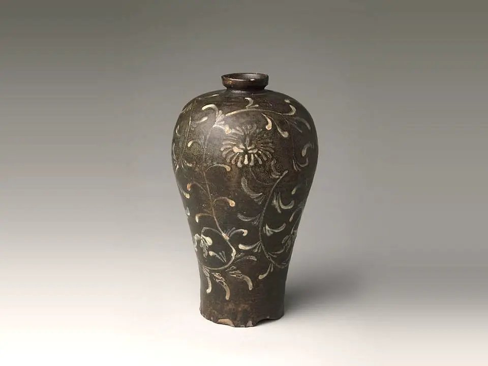 A dark iron-glazed maebyeong with white scrolling flowers. October 2024 drop, sold out.