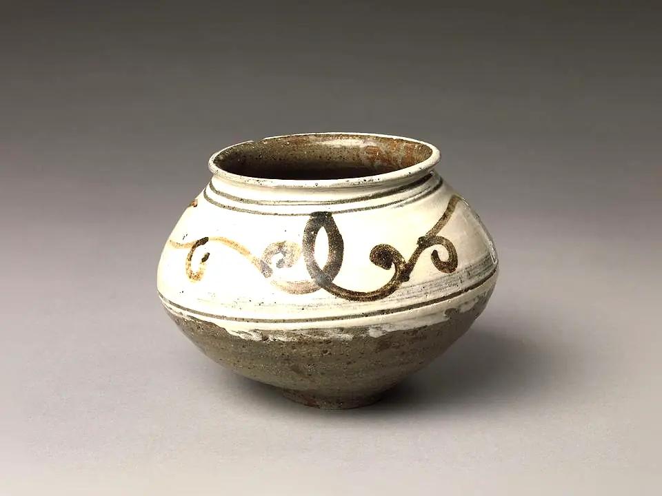 A squat jar in white slip brushed with an iron-brown scroll. September 2024 drop, sold out.